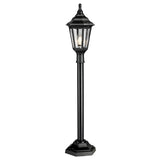 The Kinsale 1 Light Pillar Light - Black is an outdoor post light with a lantern-style design featuring a hexagonal base and clear glass panels. It showcases a decorative, traditional look with a pointed top that reveals the bulb inside, providing corrosion resistance for enduring outdoor elegance.
