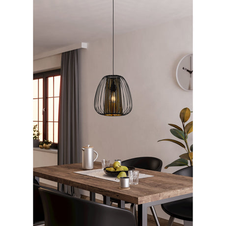 Kirelle Fabric Pendant Light in black, a single-bulb ceiling light with curved wire cage shade and gold chevron inner lining, hanging above a wooden dining table.