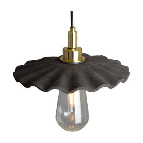 Kirhii ceramic pendant light with a wide ruffled Black Clay shade, brass fitting, and exposed clear bulb, shown on a white background.