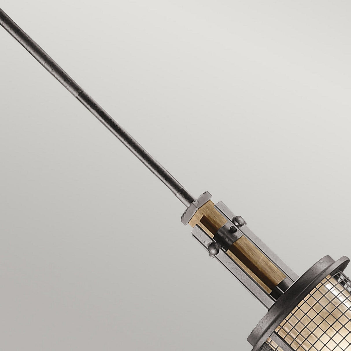 Close-up of the Ahrendale 1 Light Mini Pendant in Grey, featuring an industrial-inspired design with a grid-patterned glass shade. This rustic pendant light is suspended from a long metal rod against a neutral background, adding character and charm to any space.