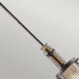 Close-up of the Ahrendale 1 Light Mini Pendant in Grey, featuring an industrial-inspired design with a grid-patterned glass shade. This rustic pendant light is suspended from a long metal rod against a neutral background, adding character and charm to any space.