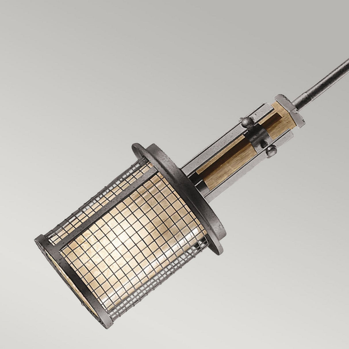 The Ahrendale 1 Light Mini Pendant - Grey features a vintage industrial-inspired design with a rustic metal grid cage surrounding a glowing bulb, elegantly hanging from a rod against a light gray backdrop.