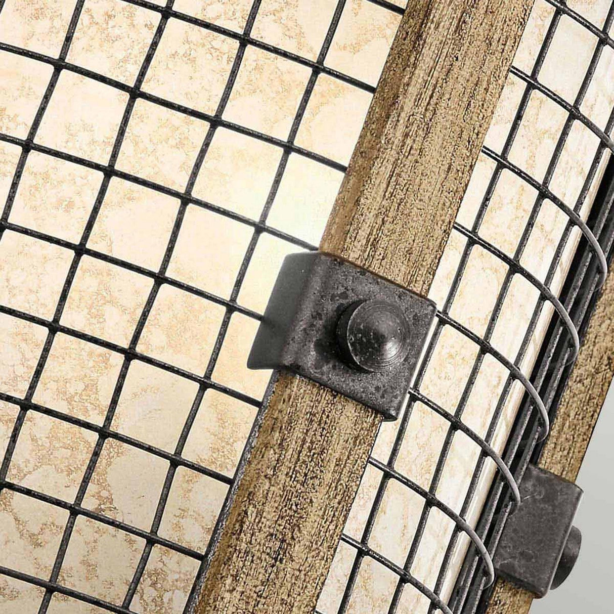 A close-up of the Ahrendale 1 Light Wall Light - Grey showcases its grid-style metal and wood frame. The light diffuses through a textured Vetro Mica shade positioned behind the grid. A metal bracket with a bolt secures the frame, embodying an Anvil Iron mesh aesthetic for added charm.