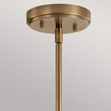 A close-up view showcases the Aivian 3 Light Chandelier in weathered brass, featuring a circular base and a straight rod that extends downward, perfectly embodying industrial aesthetics against a neutral backdrop.