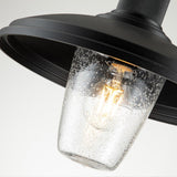The Allenbury Outdoor 1 Light Medium Wall Lantern in black is shown up close, featuring a weather-resistant build with a glass shade that contains small bubbles. Inside, an illuminated IP44 rated bulb emits a warm glow, making this lantern an ideal choice for outdoor walls.
