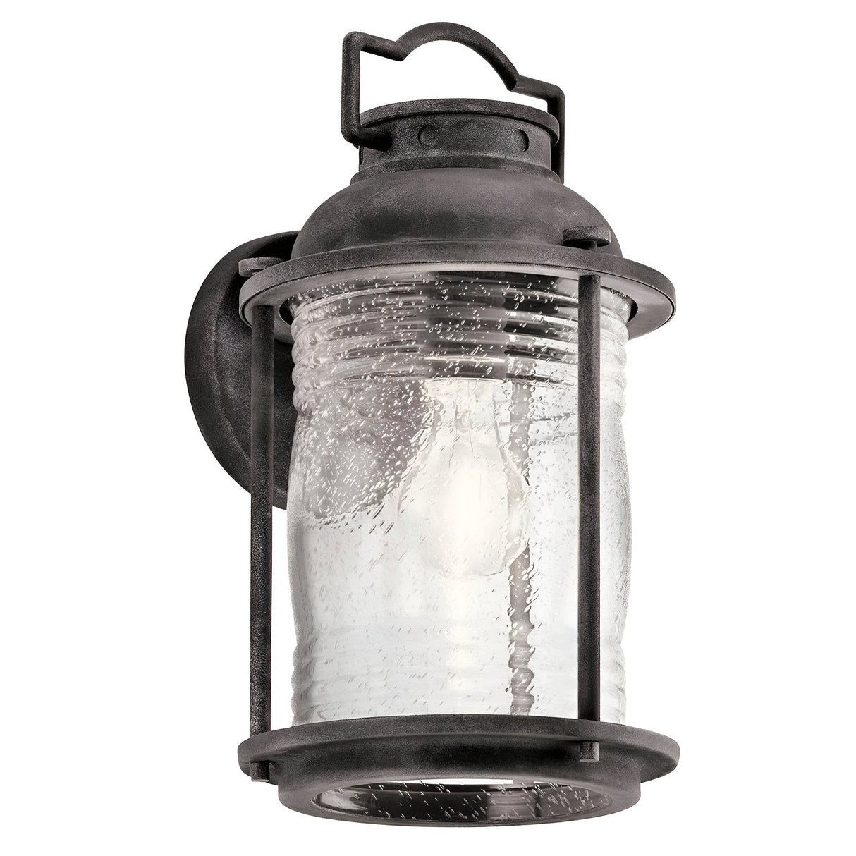 The Ashland Bay Outdoor 1 Light Medium Wall Lantern in Weathered Zinc showcases a vintage-style design with a weathered zinc metal frame and clear seeded glass encasing a single bulb. It features a curved top with a loop detail for hanging, imparting timeless charm to any setting.