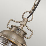 Capture the charm of an outdoor colonial-style lantern with a close-up of the Ashland Bay Outdoor 1 Light Small Chain Lantern in Burnished Bronze. Its vintage-style design showcases a textured glass enclosure, curved handle, and chain, adding rustic elegance to any space.