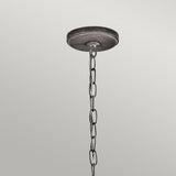 The Ashland Bay Outdoor 1 Light Small Chain Lantern in weathered zinc hangs vertically against a light gray background, beautifully complementing its attached round, dark fixture. The LED Edison-style bulbs enhance the rustic charm of this design.
