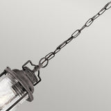 The Ashland Bay Outdoor 1 Light Small Chain Lantern in weathered zinc metal features a glass cover, LED Edison-style bulbs, and is suspended by a linked chain against a neutral background.