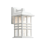 Beacon Square Outdoor 1 Light Small Wall Lantern - White features a rectangular frame with glass panels showcasing a textured design. This craftsman-inspired light fixture offers a modern, clean style, complete with a protective cover on top and mounted on a matching white base.