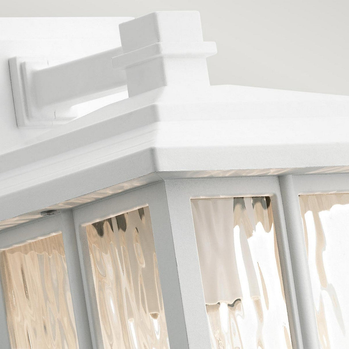 Close-up of the Beacon Square Outdoor 1 Light Small Wall Lantern in white, showcasing its craftsman-inspired design. This lantern is mounted on a square base and features UV-resistant textured glass panels that enhance its clean and elegant appearance.
