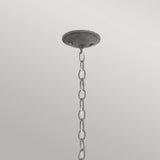 A Bridge Point Outdoor 1 Light Small Chain Light in weathered zinc descends before a gray background, hanging from a round ceiling mount. The chain links, evoking nautical charm, are evenly spaced.