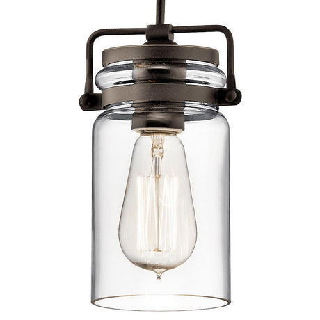 The Brinley 1 Light Mini Pendant - Bronze is a vintage-style hanging light fixture, ideal for rustic interiors, featuring a clear glass jar-shaped shade with a visible Edison bulb, elegantly suspended by a black and bronze pendant frame.