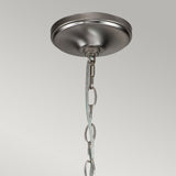 Close-up view of the Capitol Hill 12 Light Chandelier in brushed nickel, featuring a round base and a chain for suspension, set against a neutral gray backdrop.