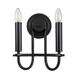 The Capitol Hill 2 Light Wall Light - Black is a wall sconce with a minimalist design, featuring two candle-shaped bulbs on vertically aligned cylindrical holders, complemented by a rounded base and curved support arms for elegant ambient lighting.