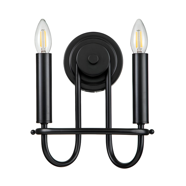 The Capitol Hill 2 Light Wall Light - Black is a wall sconce with a minimalist design, featuring two candle-shaped bulbs on vertically aligned cylindrical holders, complemented by a rounded base and curved support arms for elegant ambient lighting.