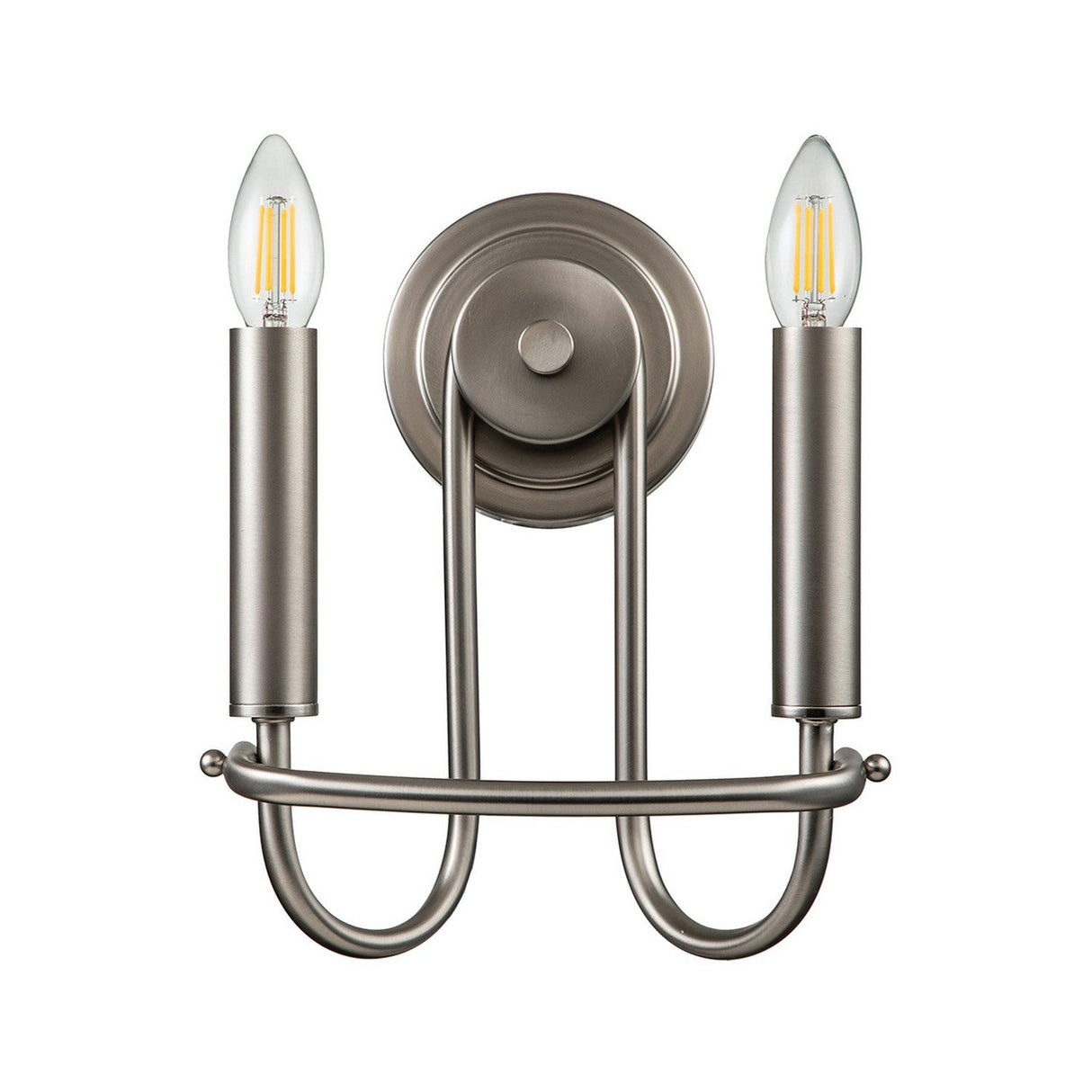 Introducing the Capitol Hill 2 Light Wall Light in Brushed Nickel, featuring a contemporary design with two cylindrical holders and exposed bulbs for a candle flame effect. This elegant sconce is mounted on a circular base with an elegantly curved metal structure.