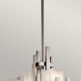 The City Lights 7 Light Chandelier - Silver exudes sophistication with its sleek metallic structure, featuring LED lighting and multiple rectangular frosted glass shades, elegantly suspended from a lengthy rod against a plain background.