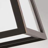 A close-up view of the Delison Outdoor 1 Light Wall Lantern in Rubbed Bronze, illustrating its geometric metal frame with sharp edges and a glass panel. The IP44-rated fixture is captured from below, highlighting its clean lines and modern design against a neutral backdrop.