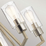 Close-up of two contemporary light fixtures featuring clear glass shades and exposed Edison bulbs. With metallic bases and wooden arms, these fixtures create a geometric pattern against a neutral backdrop, exuding a rustic charm akin to the Deryn 5 Light Chandelier in Antique Grey.
