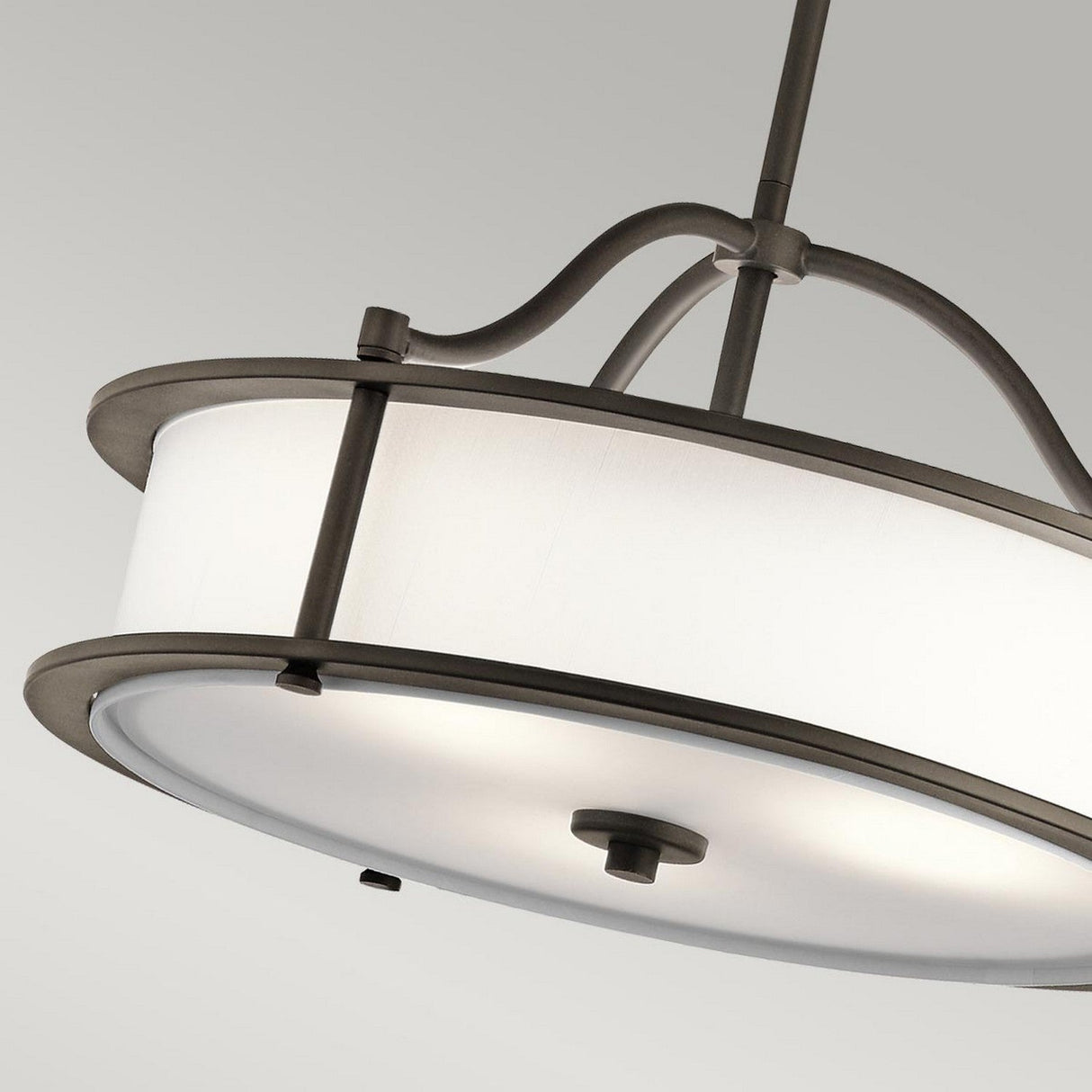 The Emory 3 Light Duo-Mount Pendant/Semi-Flush in Olde Bronze showcases a circular white fabric drum shade, elegantly complemented by curved metal supports and a central stem. Set against a plain gray background, it adds sophistication to any contemporary setting.