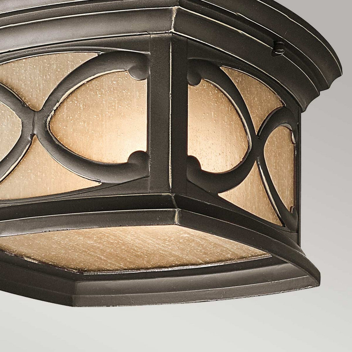 Here’s a revised version using the product data:

A close-up of the Franceasi Outdoor 2 Light Flush, showcasing its octagonal design with an Olde Bronze frame adorned with intricate patterns. Its frosted glass panels, accented by some amber-tinted sections, elegantly diffuse the light.