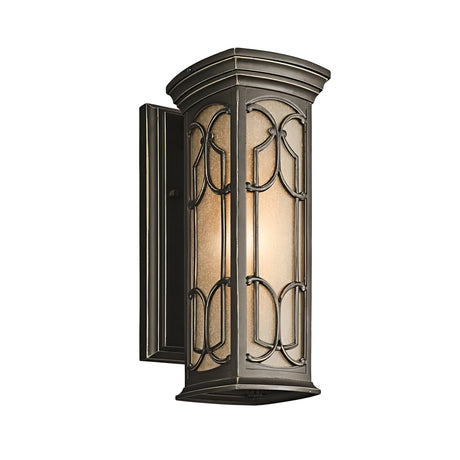 The Franceasi Outdoor 1 Light Small Wall Lantern in Olde Bronze features a rectangular design with decorative metal accents and amber-tinted glass panels, softly lighting up the area.
