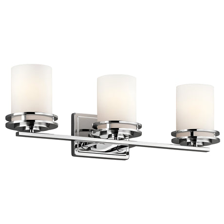 Introducing the Hendrik 3 Light Wall Light in polished chrome, featuring three horizontally arranged cylindrical white frosted glass shades. This modern fixture, with an IP44 rating, includes a sleek rectangular backplate and horizontal bar to gracefully illuminate your bathroom.