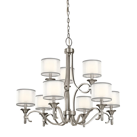 The Lacey 9 Light Chandelier - Silver showcases a stunning silver finish and features nine lights adorned with cylindrical frosted glass shades. Its elegant metal frame with gracefully curved arms is suspended by a chain, providing a modern dual-shade design that elevates any contemporary space.