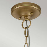 A close-up of the Larkin 3 Light Medium Chandelier in natural brass shows its circular ceiling mount. The metal hook is attached to a linked chain, perfect for hanging a fixture. Its backdrop is plain and light-colored, reflecting the elegant simplicity of its open cage design.