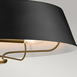 Close-up of the Luella 4 Light Duo-Mount Chandelier/Semi-Flush in Black & Brass, a modern ceiling light fixture. The design showcases a sleek, angled shade with an exposed bulb, emphasizing its contemporary and minimalistic style. Its versatile duo mount option allows it to enhance any space effortlessly.