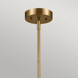 A detailed look at the Luella 4 Light Duo-Mount Chandelier/Semi-Flush in brushed natural brass, showcasing its cylindrical base and sleek, minimalist design. The fixture's smooth finish complements its elegant placement against a light gray ceiling.