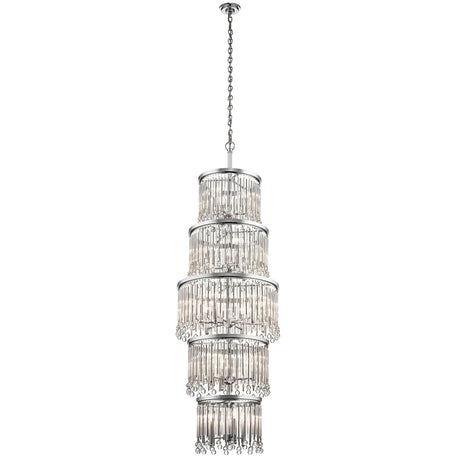 The Piper 18 Light Chandelier - Polished Chrome is a tall, elegant fixture featuring multiple tiers of hanging crystal tubes suspended from a polished chrome chain. Its design creates a cascading effect, reflecting light beautifully and adding a touch of luxury. Glass bead accents further enhance the frame's sophisticated appearance.