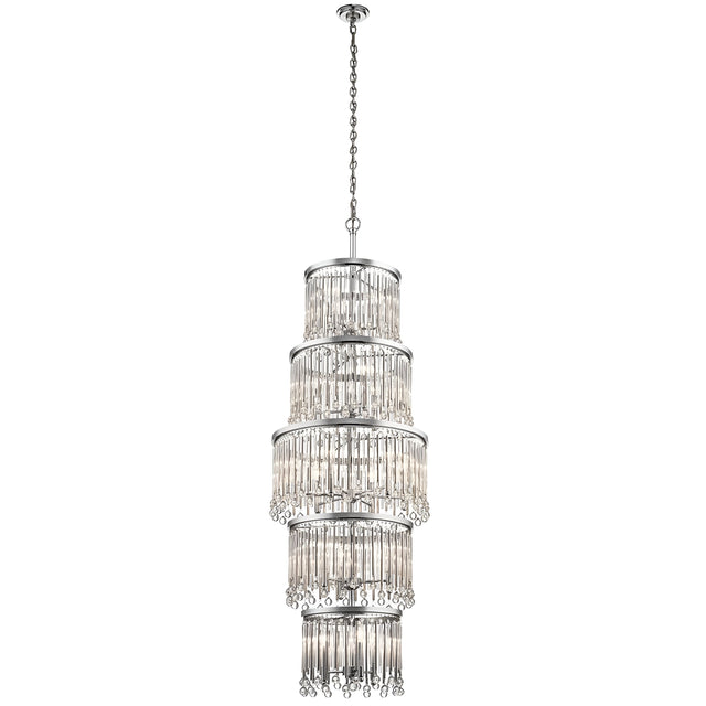 The Piper 18 Light Chandelier - Polished Chrome is a tall, elegant fixture featuring multiple tiers of hanging crystal tubes suspended from a polished chrome chain. Its design creates a cascading effect, reflecting light beautifully and adding a touch of luxury. Glass bead accents further enhance the frame's sophisticated appearance.