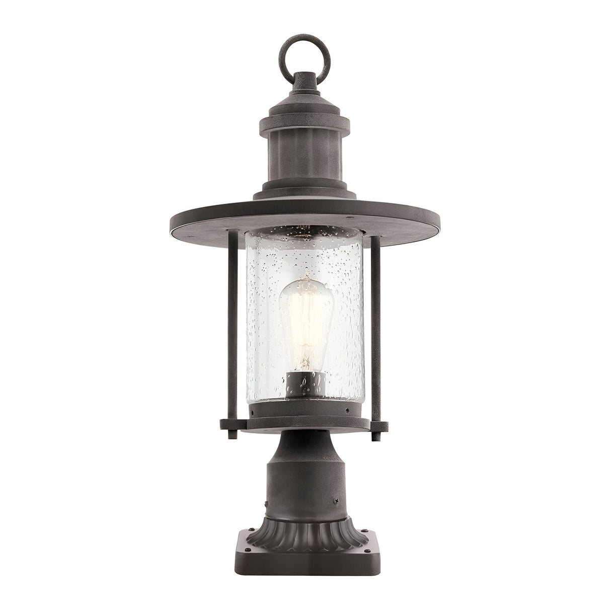 The Riverwood Outdoor 1 Light Pedestal Lantern in weathered zinc features a black nautical-inspired vintage design. It includes a circular top and clear glass housing that encloses an exposed light bulb, all resting on a square base ideal for outdoor use.