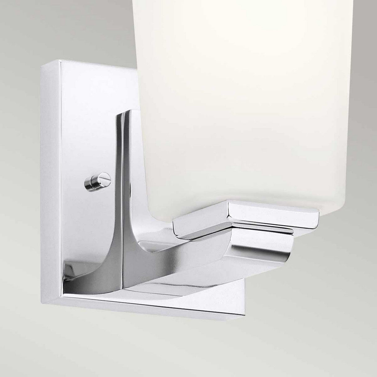 Close-up of the Roehm 1 Light Wall Light in polished chrome featuring an opal glass shade. This IP44 rated fixture is mounted on a square, metallic base against a plain background.