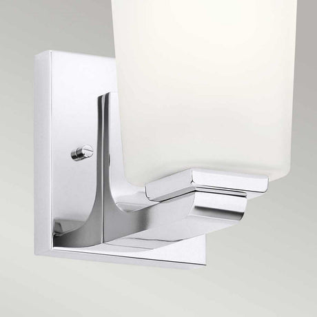 Close-up of the Roehm 1 Light Wall Light in polished chrome featuring an opal glass shade. This IP44 rated fixture is mounted on a square, metallic base against a plain background.