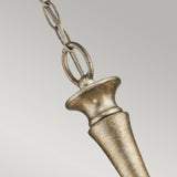 A detailed view of the Rosalie 5 Light Mini Chandelier in sterling gold, showcasing a conical pendant suspended from a metal chain against a soft gray background. The pendant boasts a smooth, polished surface and features a tapered design that evokes the look of antique mercury glass.