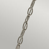 A close-up image of the Rosalie 1 Light Pendant in Sterling Gold, featuring a metal chain suspended diagonally against a plain gray background, evokes the charm of Williamsburg design. The chain consists of interlinked oval-shaped links with a slightly weathered texture, reminiscent of antique mercury glass.