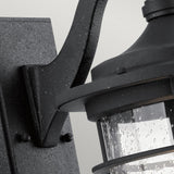 Close-up of the Royal Marine Outdoor 1 Light Medium Wall Lantern in black, featuring a rain-splattered glass cover. This metal fixture exudes vintage appeal with its textured, speckled finish, offering a classic and weathered look that enhances any outdoor lighting setup.