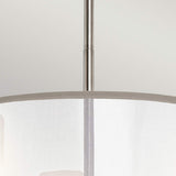 A close-up of the Saldana 3 Light Chandelier - Silver showcases its graceful organza shade and polished metallic rod, beautifully contrasted against a light gray background.