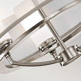 Close-up of a modern ceiling light fixture with a brushed nickel finish. The Saldana 3 Light Chandelier - Silver design showcases curved metal bars and frosted glass, offering a sleek and contemporary look.