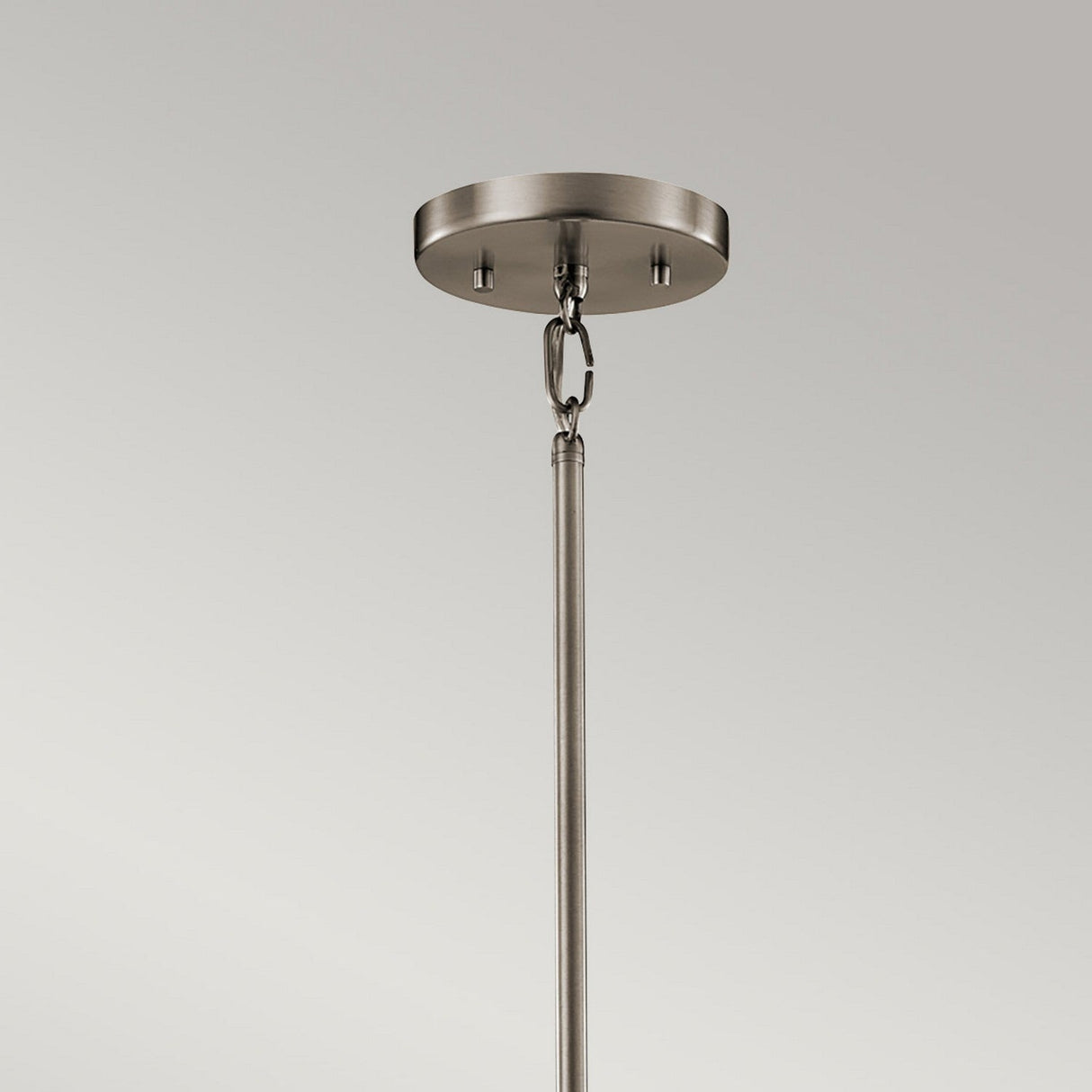 Close-up of the Silver Coral 1 Light Mini Pendant in a brushed nickel finish, featuring a circular base and a rod connected by a metal chain, exuding a contemporary feel. Its sleek design reflects the elegance of nature-inspired elements, set against a plain light grey background.