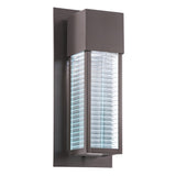 The Sorel Outdoor 1 Light Wall Lantern in Bronze features a modern rectangular design with a textured glass center, emitting a bright white glow.