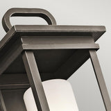 Close-up of the South Hope Outdoor 1 Light Medium Wall Lantern in Rubbed Bronze featuring a rectangular handle, with clean lines and an opal glass interior light fixture. This sleek design is set against a plain white background.