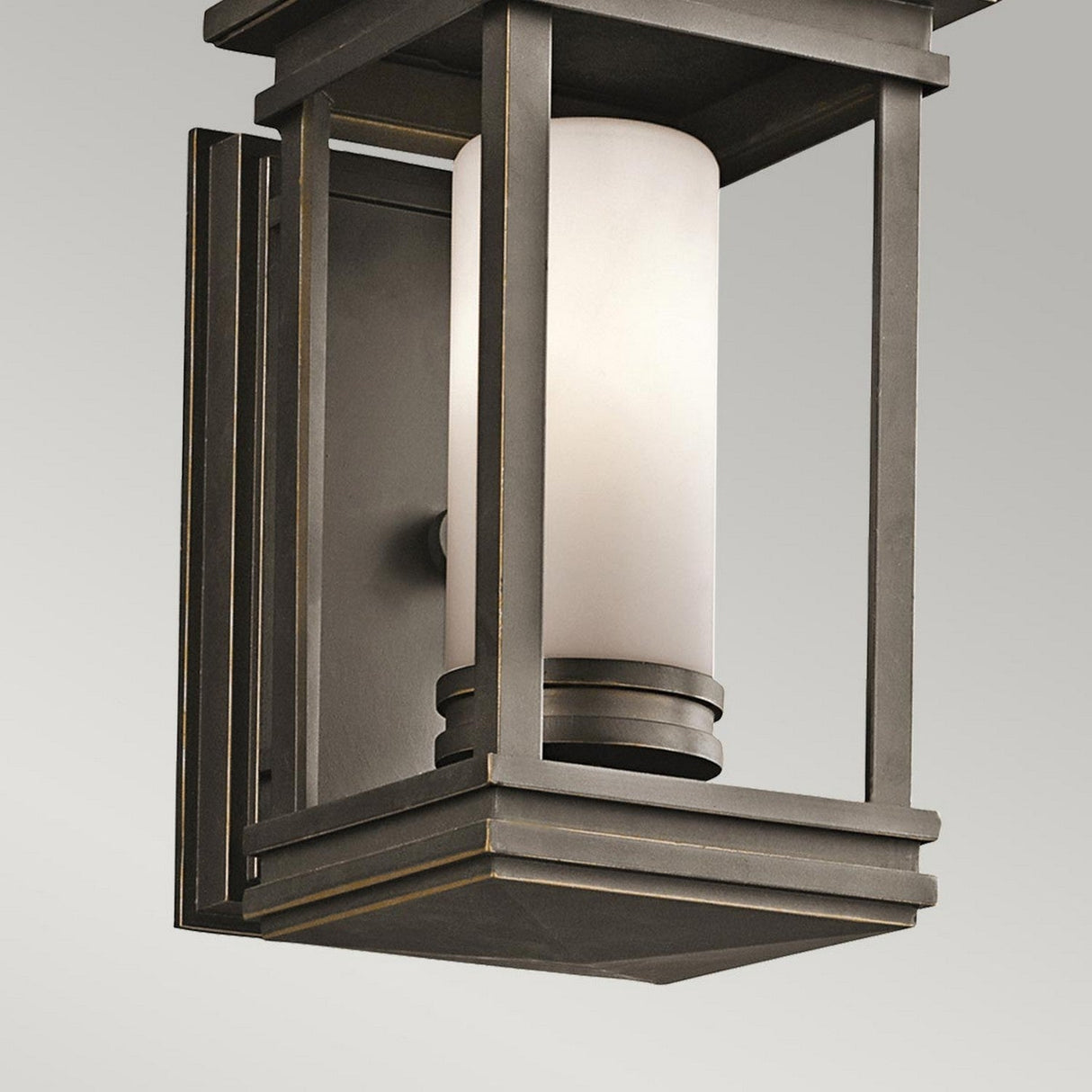 Introducing the South Hope Outdoor 1 Light Small Wall Lantern, showcasing a sleek and minimalistic design with its square rubbed bronze frame and opal glass shade, making it an ideal choice for contemporary settings.