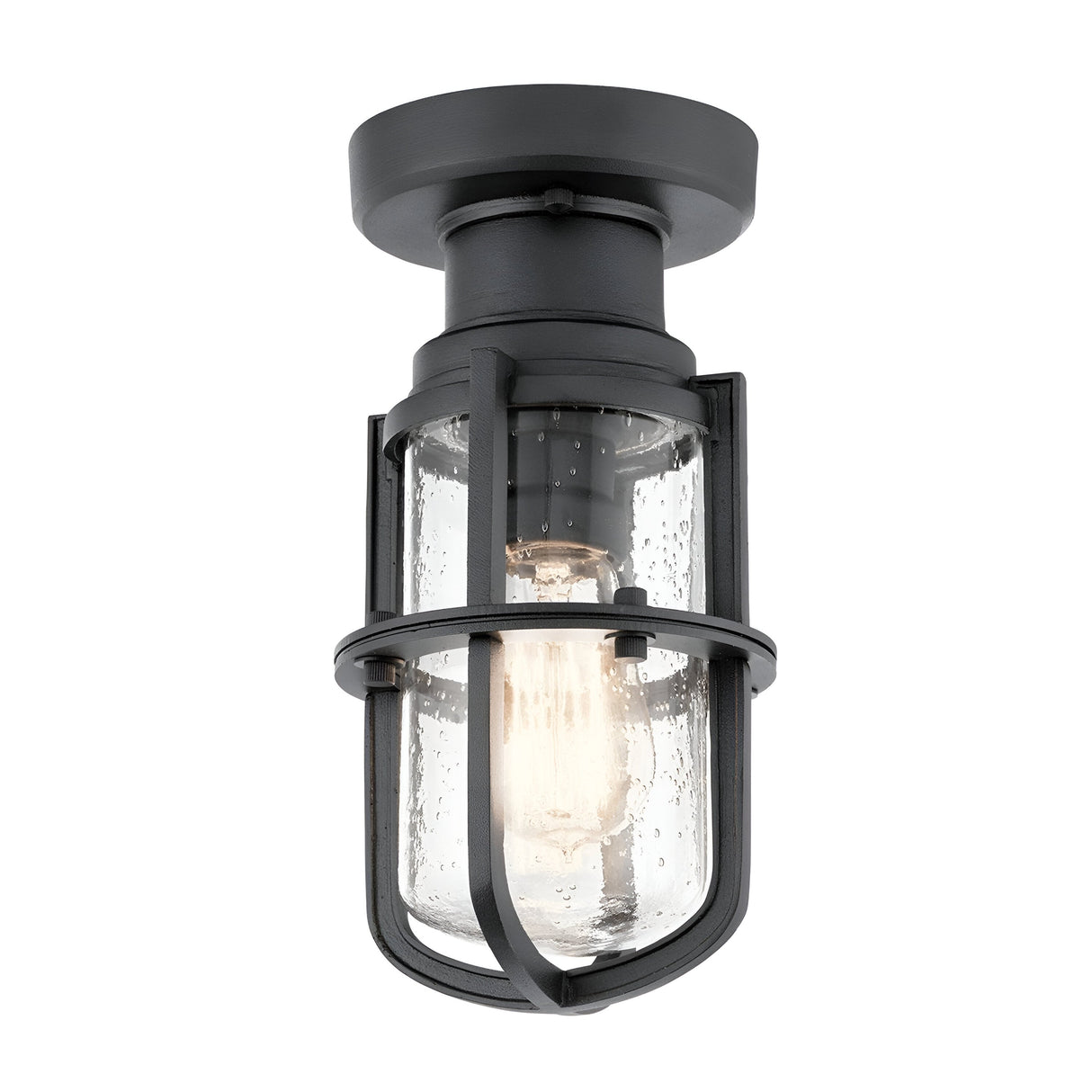 Introducing the Suri Outdoor 1 Light Porch/Pedestal Lantern in Black, featuring a textured industrial-style design with a clear glass shade and metal cage. It showcases an exposed bulb inside, adding nautical charm. This light is mounted on a round base, making it perfect for both indoor and outdoor settings.