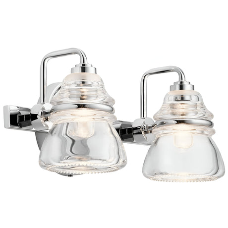 Introducing the Talland 2 Light Wall Light in Polished Chrome, featuring a modern design with two vintage-inspired glasswork shades. This sleek metal fixture and clear glass elegantly display the light bulbs within, offering a contemporary aesthetic that complements various interior styles.