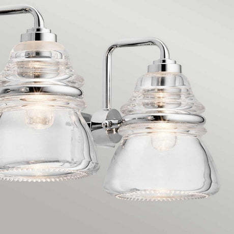 Close-up of the Talland 4 Light Wall Light in polished chrome, showcasing its two vintage glass shades with visible bulbs inside. The chrome elements provide a sleek, contemporary touch against a neutral background, making it an ideal choice for sophisticated bathroom lighting.