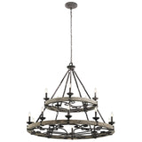 The Taulbee 15 Light Chandelier, featuring a weathered zinc finish, hangs from the ceiling with twelve candle-like lights beautifully displayed around two circular metal frames. These are linked by metal rods and chains, capturing an industrial and vintage aesthetic.